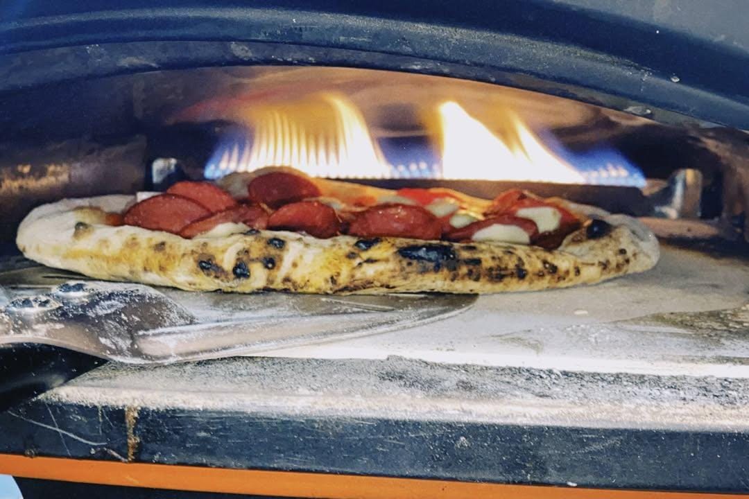 A wood-fired Heningan Pizza, with space marked for the brands still to join the group